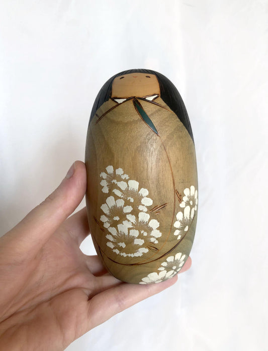Cute wooden kokeshi doll with delicate flowers pattern by Usaburo