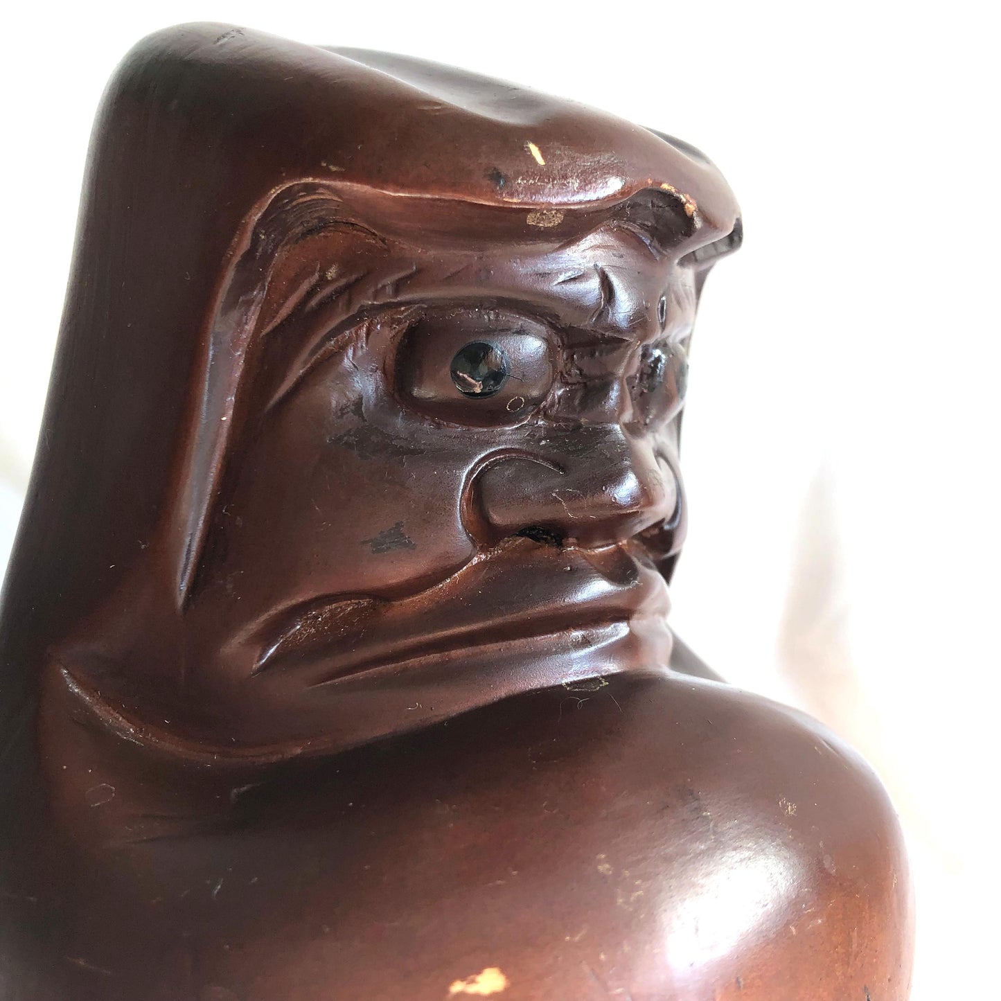 Pensive wooden Daruma figurine