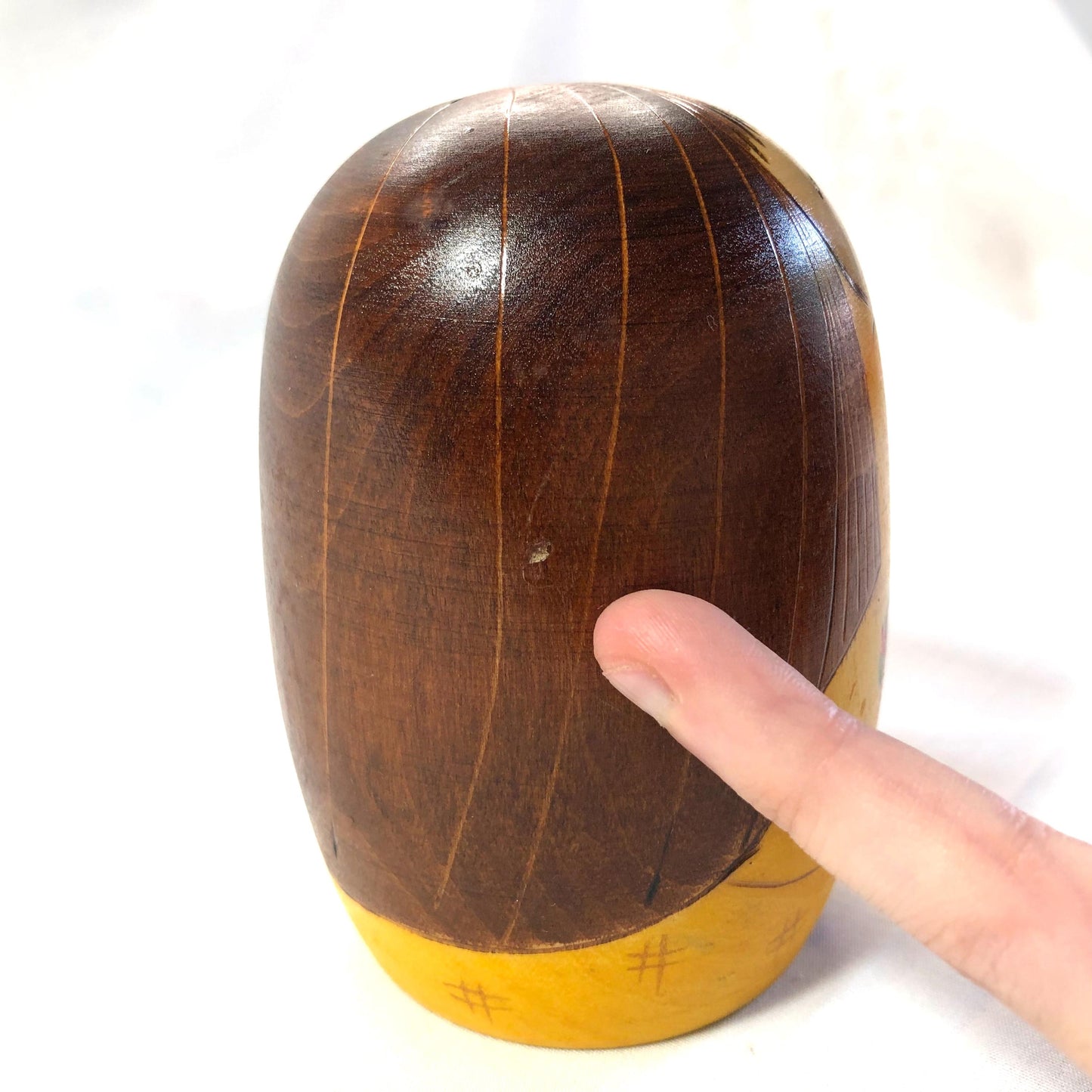 Joyful wooden kokeshi doll with a basket of flowers