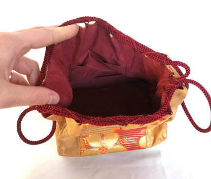 Elegant Japanese drawstring bag kinchaku - golden with floral accent