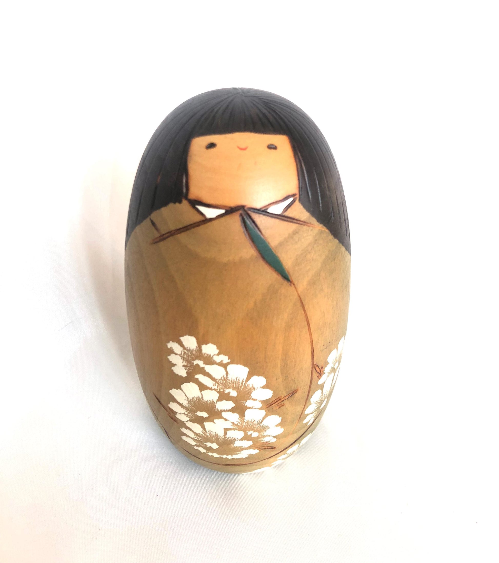 Cute wooden kokeshi doll with delicate flowers pattern by Usaburo