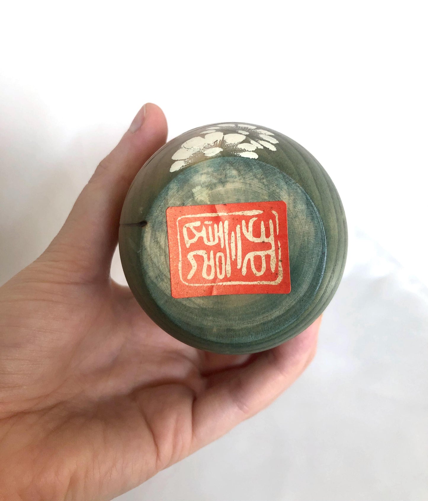 Cute wooden kokeshi doll with delicate flowers pattern by Usaburo