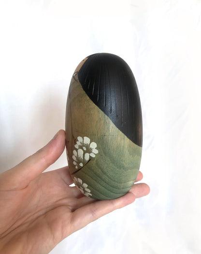 Cute wooden kokeshi doll with delicate flowers pattern by Usaburo