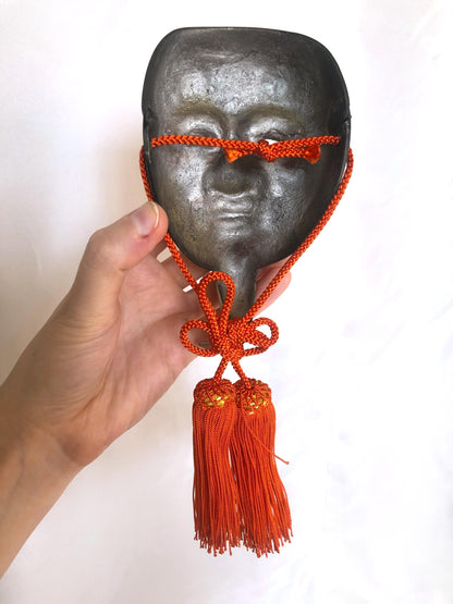 Japanese metal interior decoration - noh theater mask and a fan