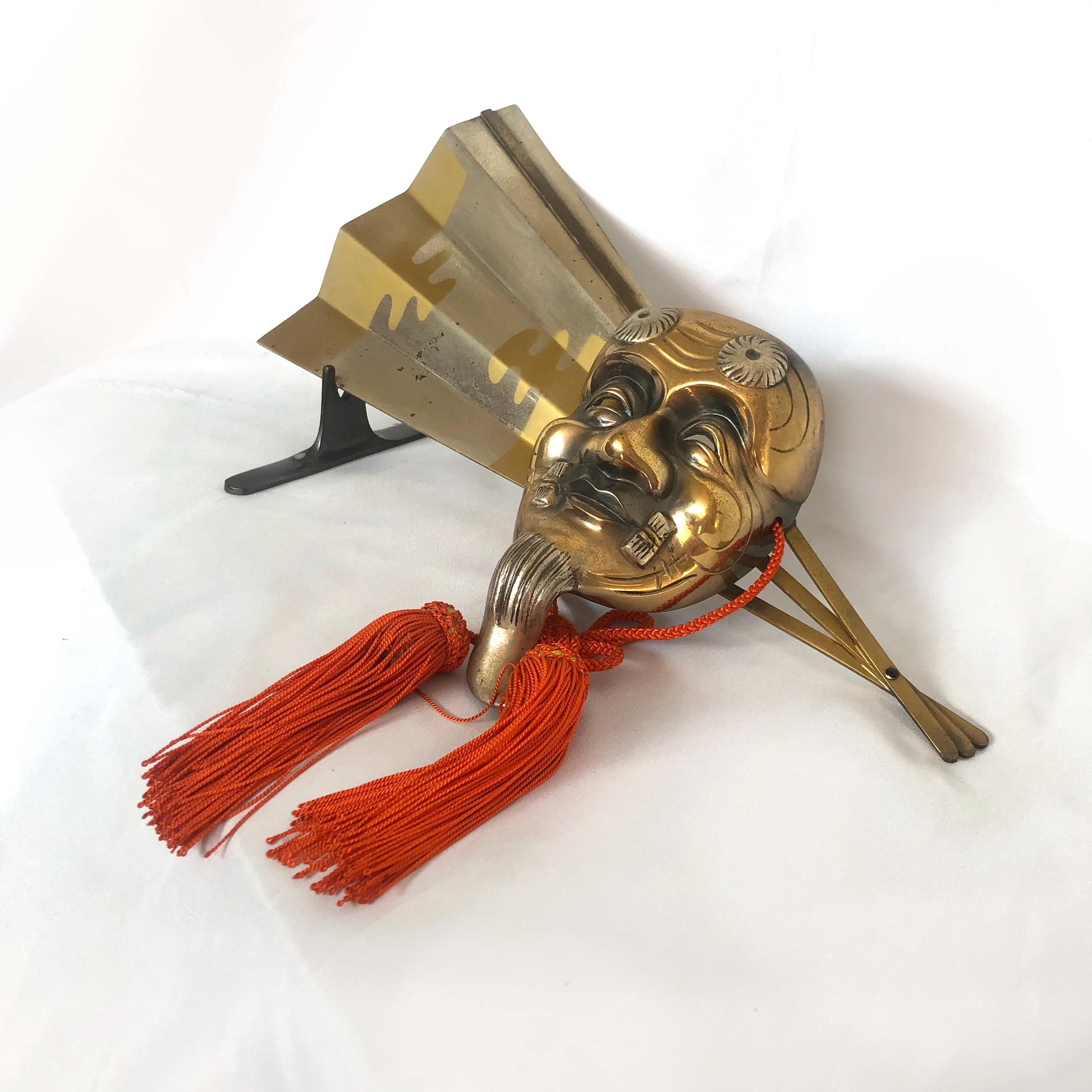 Japanese metal interior decoration - noh theater mask and a fan