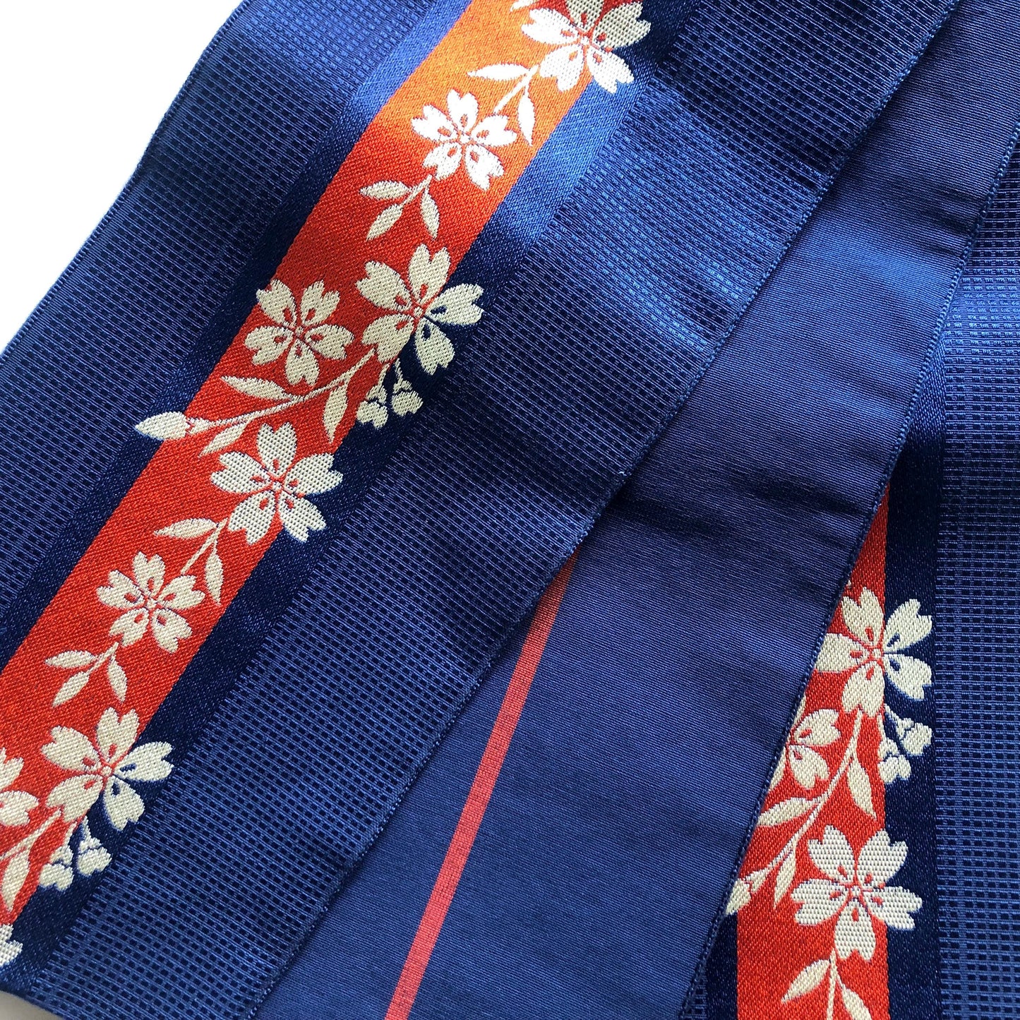 Reversible Japanese hanhaba obi - saturated blue with red stripe and cream sakura flowers