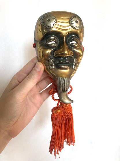 Japanese metal interior decoration - noh theater mask and a fan