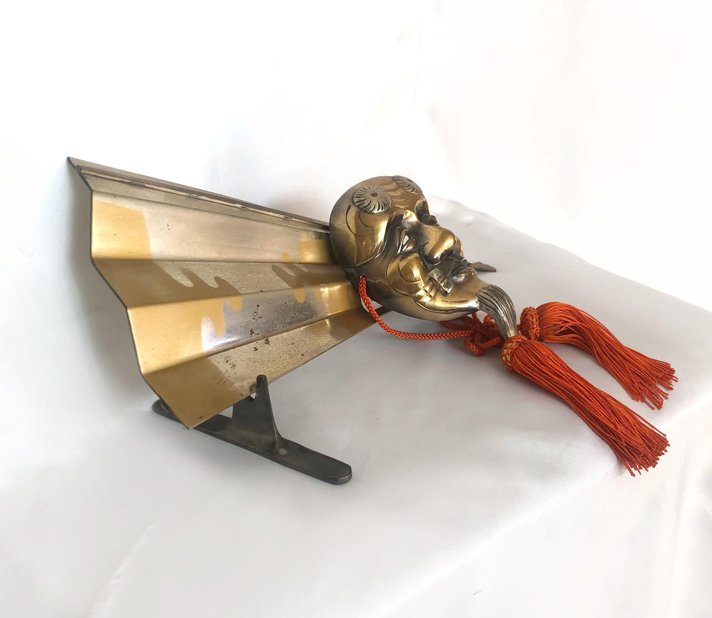 Japanese metal interior decoration - noh theater mask and a fan