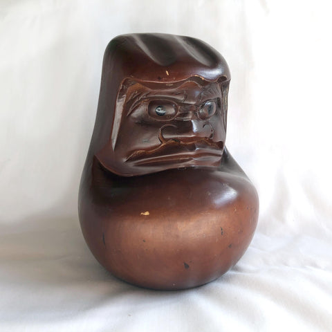 Pensive wooden Daruma figurine