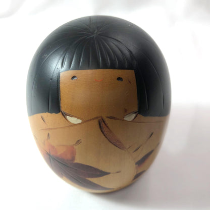 Cute wooden kokeshi doll with momiji leaf pattern by Usaburo