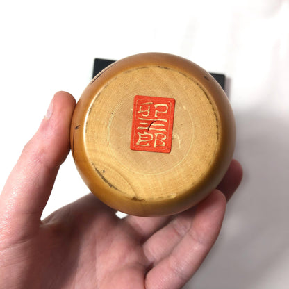 Cute wooden kokeshi doll with momiji leaf pattern by Usaburo