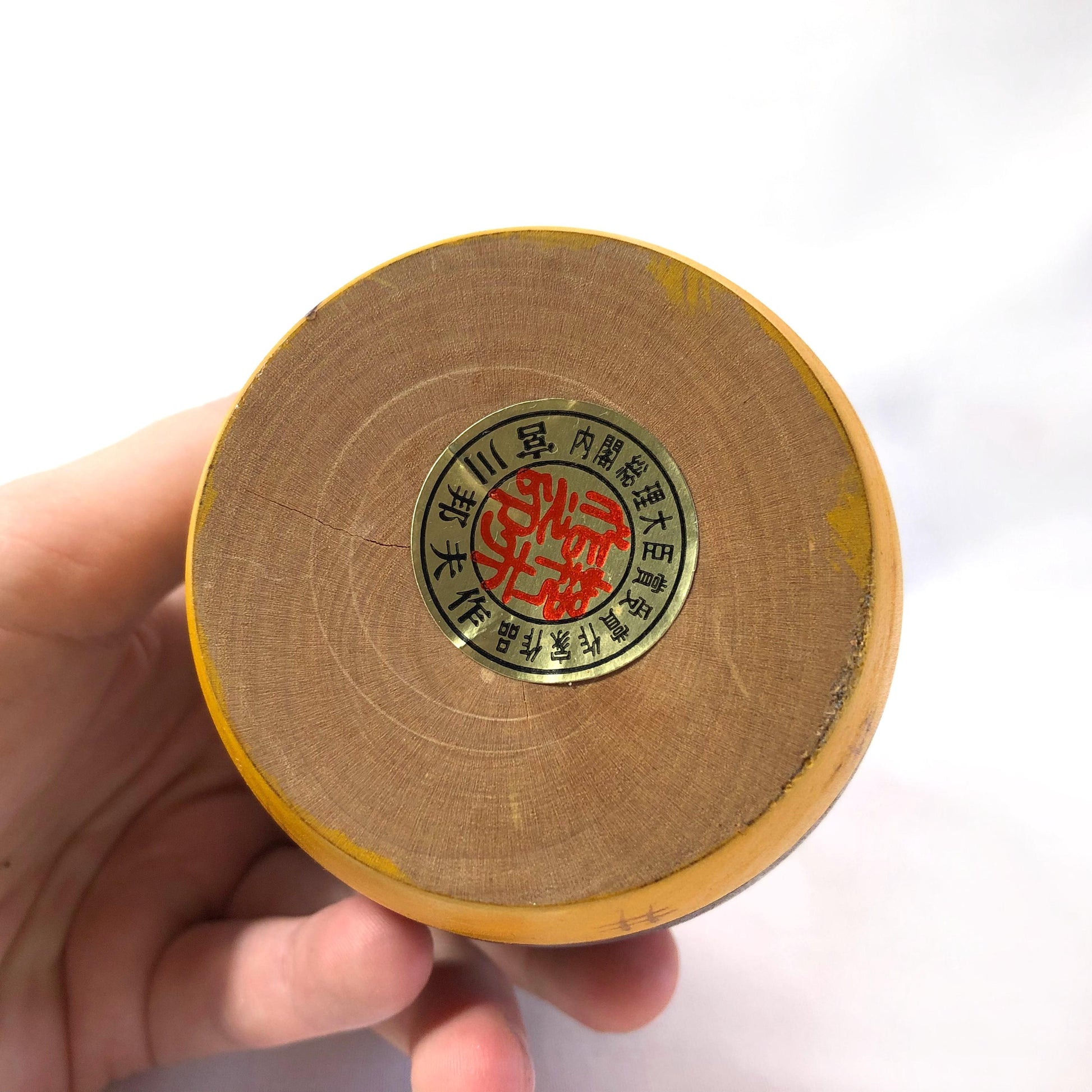 Joyful wooden kokeshi doll with a basket of flowers