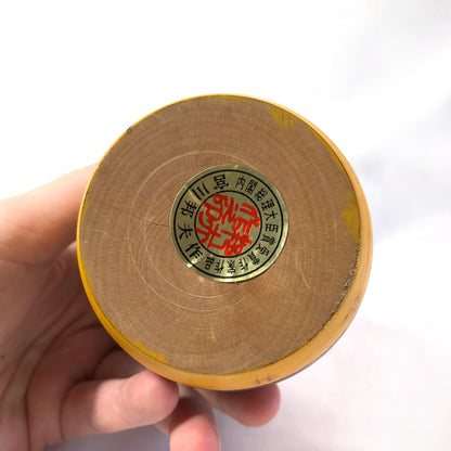 Joyful wooden kokeshi doll with a basket of flowers