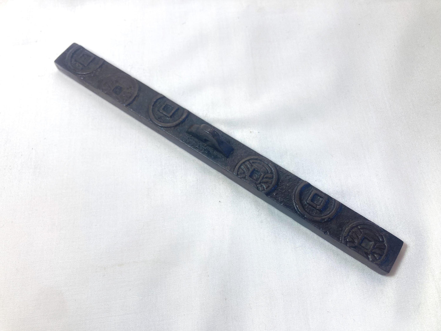Japanese iron cast paperweight - old coins bar