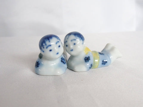 Ceramic chopstick rest-  two resting children