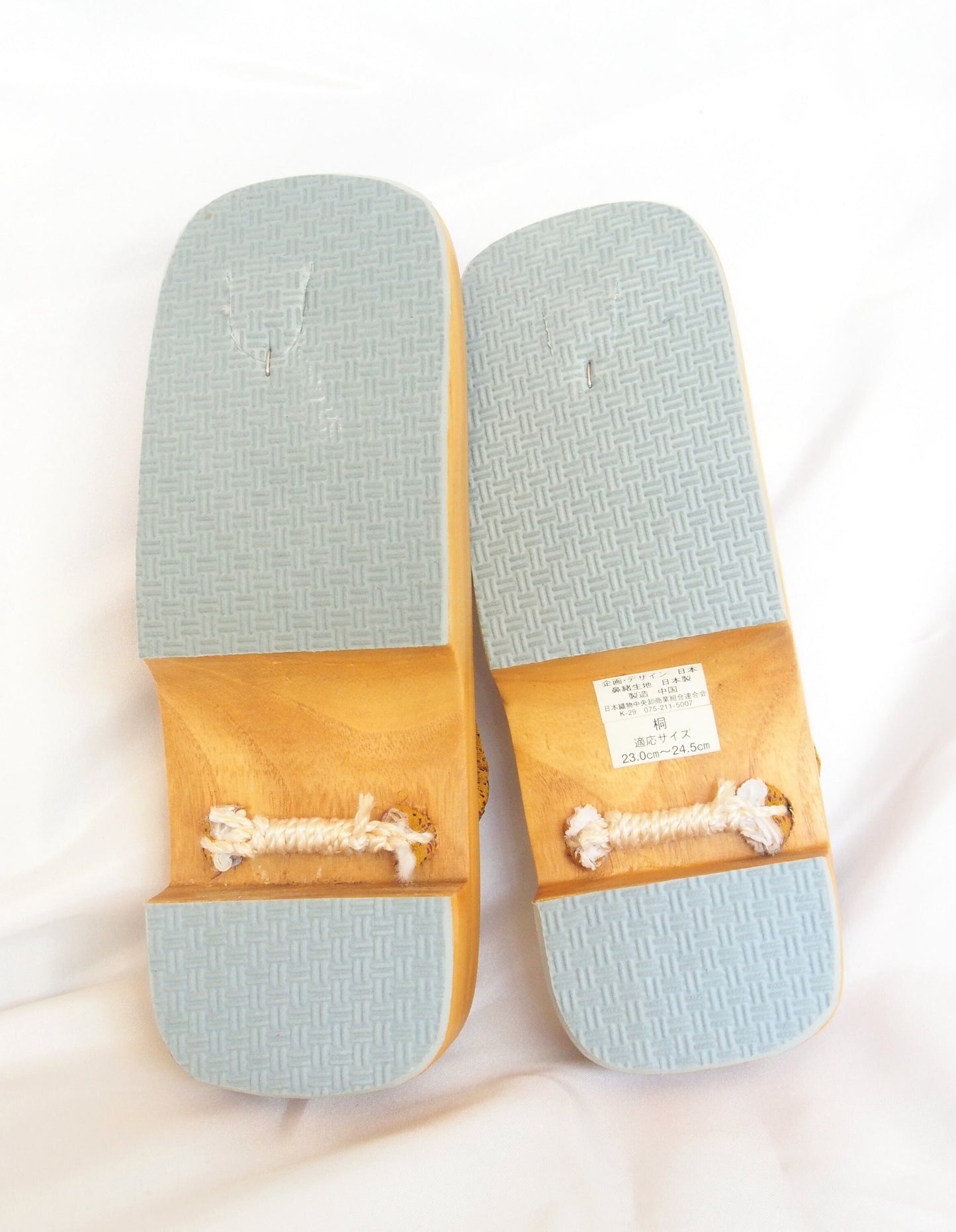 Elegant wooden geta- ocher and red traditional Japanese shoes with floral pattern